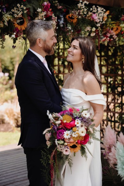 Bride looks up to groom she smiles and laughs