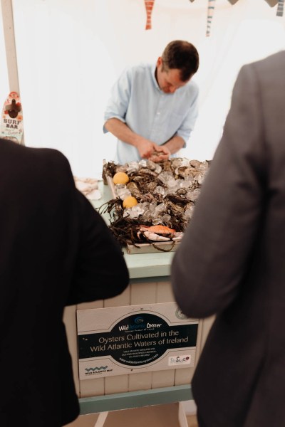 Waiter serving food mini restaurant seafood finger food for guests