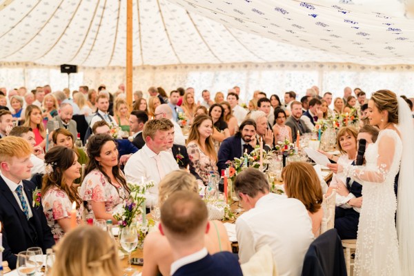 Guests seated at table bride giving speech