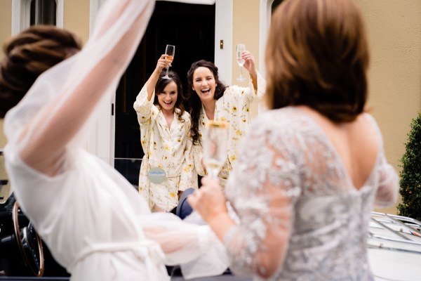 Bride mother and bridesmaids cheers with glasses of champagne