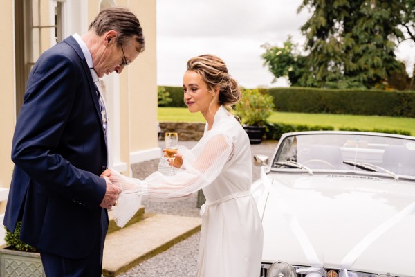 Bride and father outside at wedding car