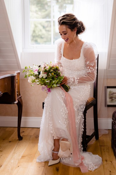 Bride seated holding bouquet flowers