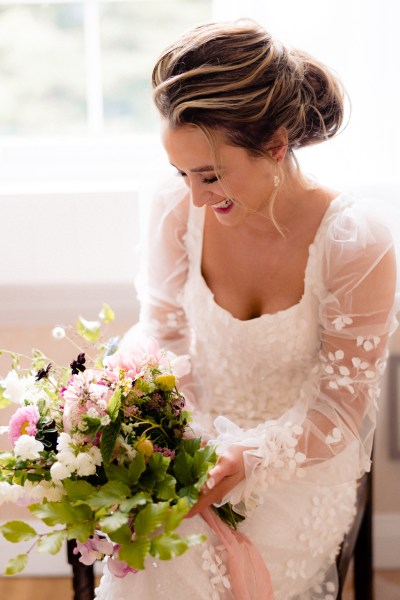 Bride seated holding bouquet flowers