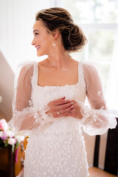 Close up of lace arm detail in bridal gown/dress ring detail