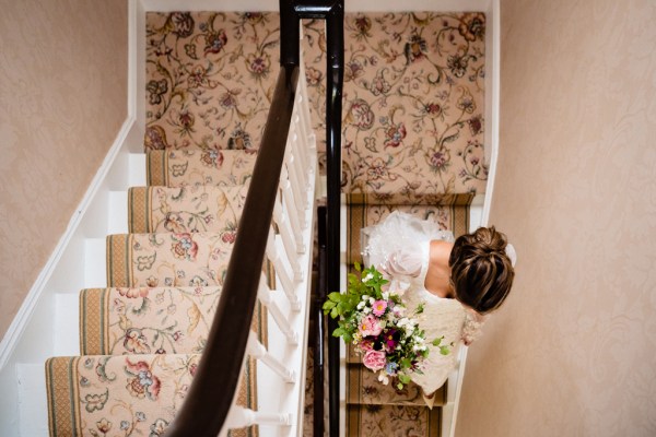 Bride makes her way down the stairs