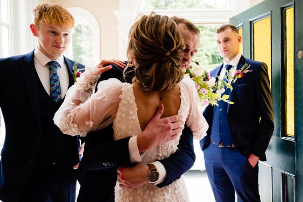 Bride is greeted by father emotional hug