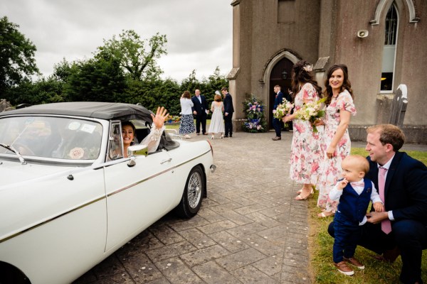 Bridesmaids and family members wait for bride at church