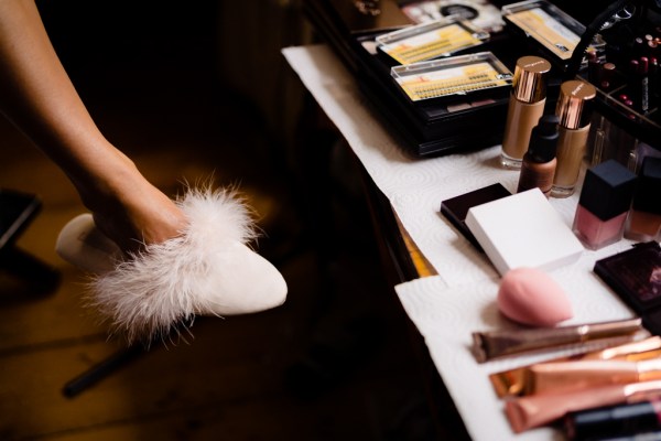 Feather fluffy slipper on brides food beside cosmetic table