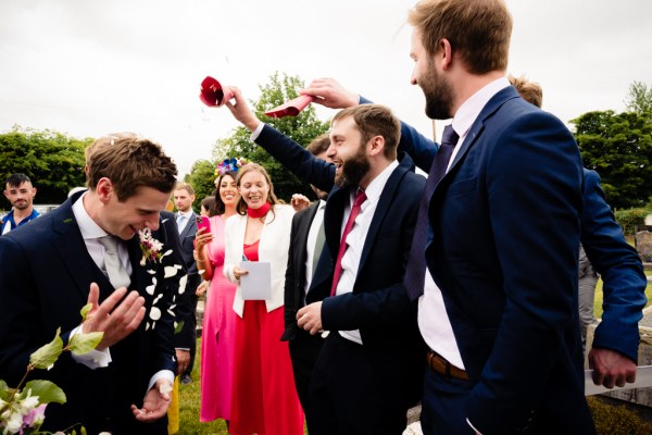 Guests cheering on the groom happy