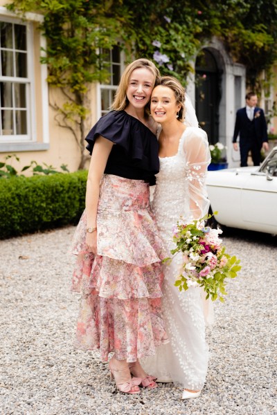 Woman and bride pose for a photo