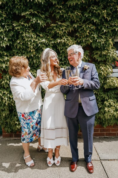 Mother and father cheers with glasses of champagne