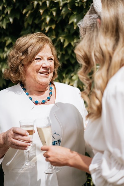 Mother and daughter bride smile and laugh