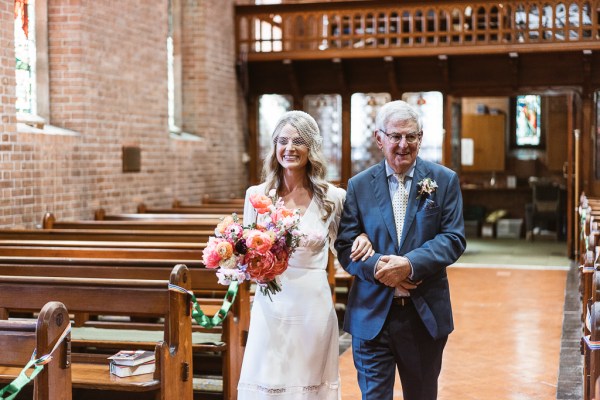 Priest and father of the bride walking her down the aisle