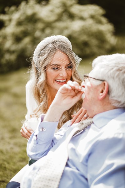 Bride and man laugh together