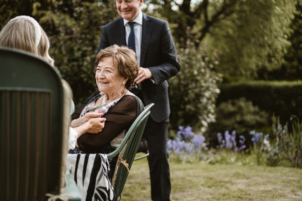 Woman sits in chair and laughs