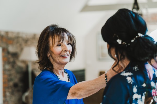 Bride and mother in blue dress