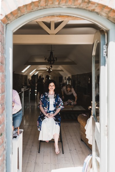 Bride sits and takes in the sun as she gets ready