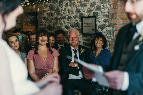 Groom reads vows to bride in front of audience