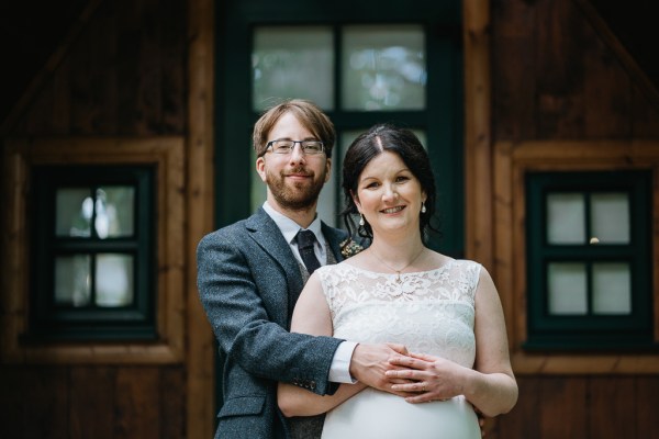 Bride and groom hug and embrace outside wedding venue