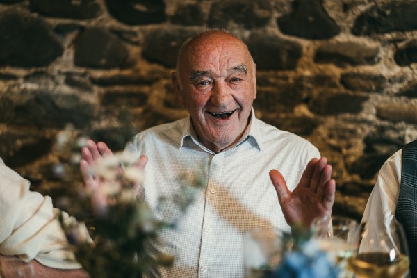 Man laughs and jokes as he gives speech