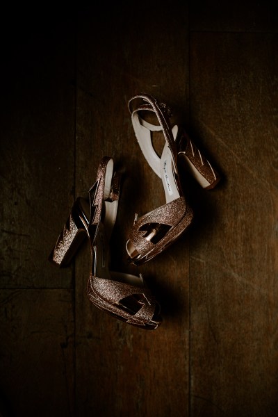 Dark photography of brides bridal heels shoes golden leather