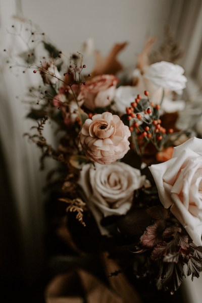 Bouquet of flowers/roses sits at windowsill close up