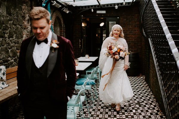 Bride follows groom walks up to surprise him