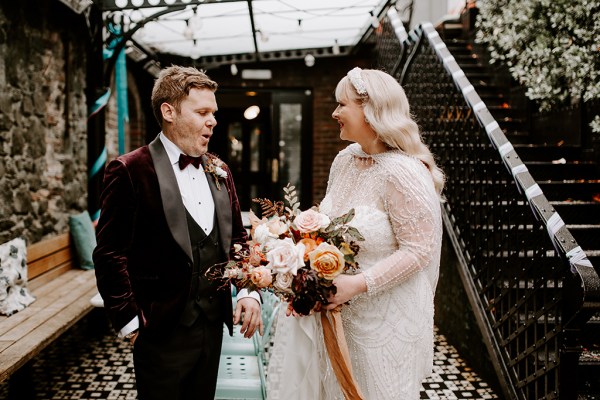 Bride and groom converse bouquet in shot