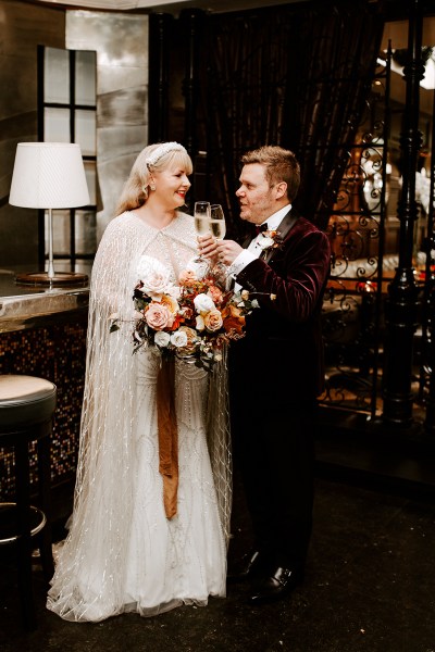 Bride and groom enjoy a glass of prosecco/champagne bar setting