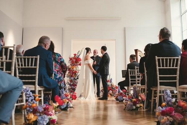 Bride and groom at the alter during wedding ceremony guests seated