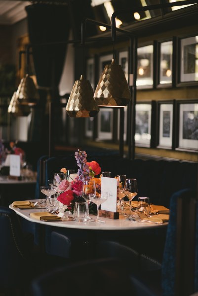 Interior pub cocktail bar setting photo frames portraits hanging on wall