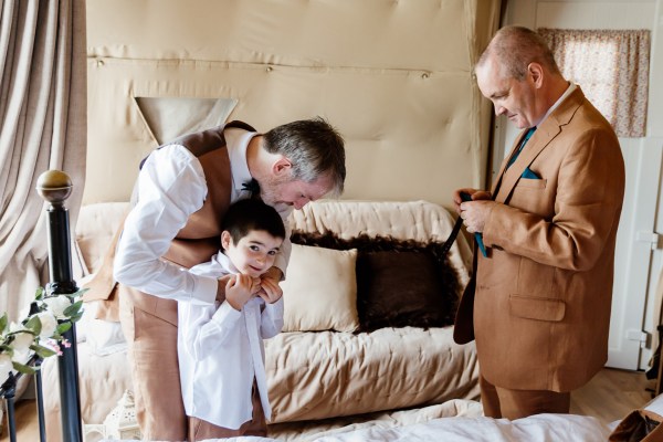 Groom son and groomsman get ready for wedding