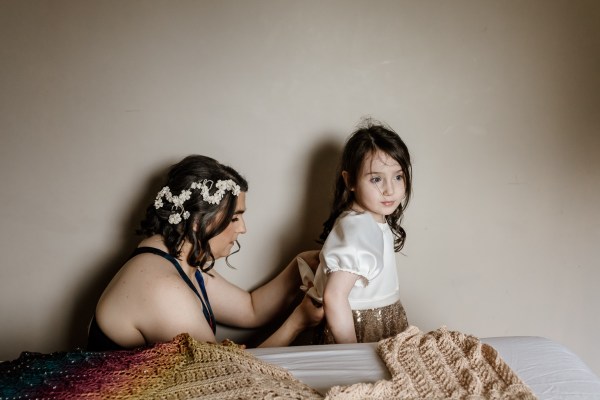 Bride fixes up back of daughters dress