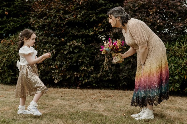 Little girl daughter and mum playing on the grass