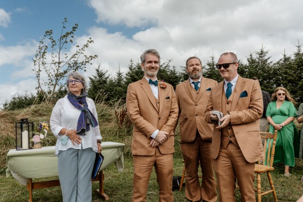 Groom and his groomsmen stand beside celebrant