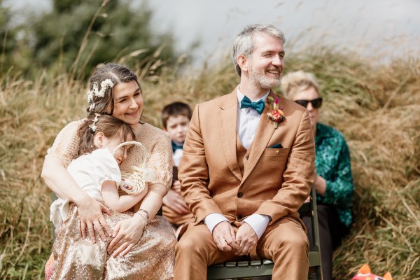 Sleepy daughter bride and groom seated