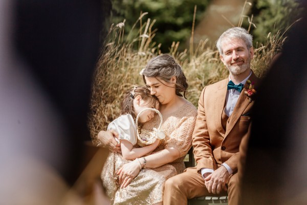 Sleepy daughter bride and groom seated