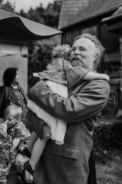 Black and white pic of father and daughter hugging