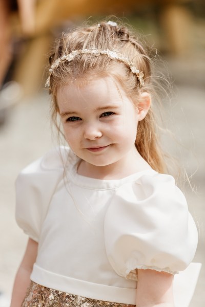 Little girl wearing headband poses for the camera