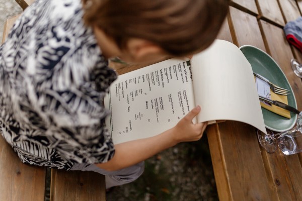 Woman looks at menu