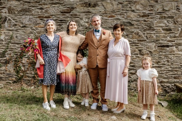 Family photo groom mother bride and two little girls daughters