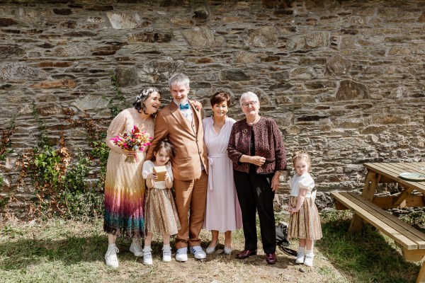 Family photo groom mother bride and two little girls daughters