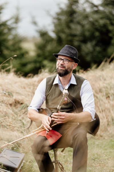 Musician flute bagpipe playing music seated