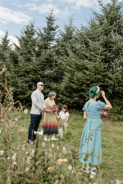 Bride and bridesmaids on the grass in forest