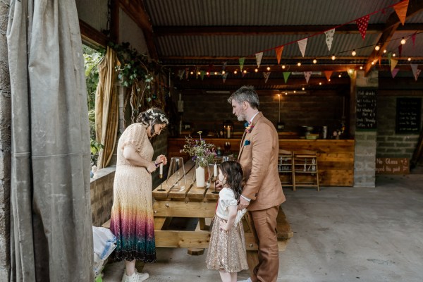 Mother father and little girl bride and groom