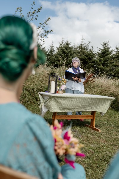 Celebrant reads sermon to guests and audience members