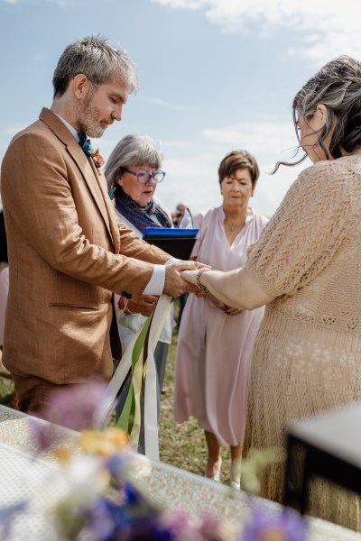 Celebrant bounds the couple together with ribbon