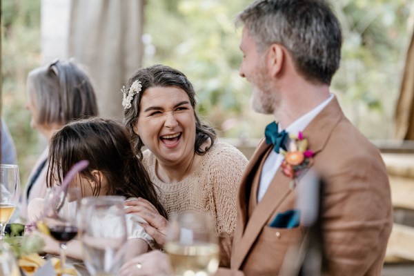 Bride and groom laugh at table