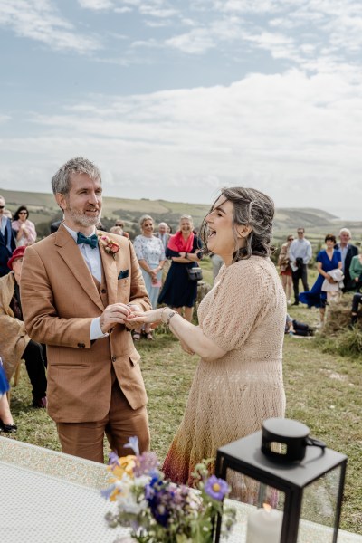 Bride and groom laugh at alter