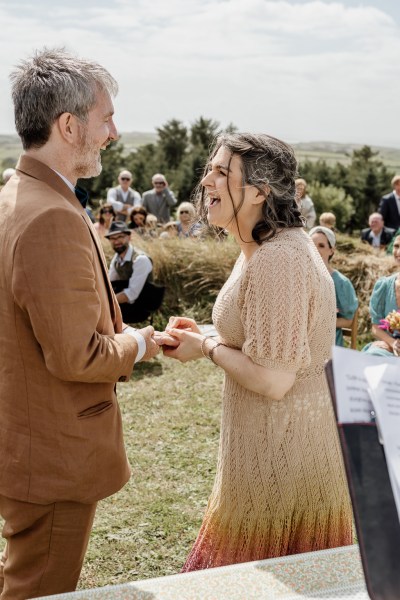 Bride and groom laugh at alter